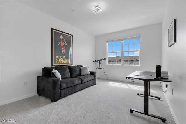 a living room with furniture a air conditioner vent and a window