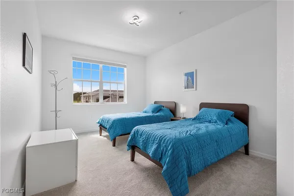 a bedroom with two beds and a couch