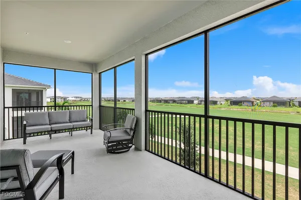 a view of a chairs and tables in the balcony