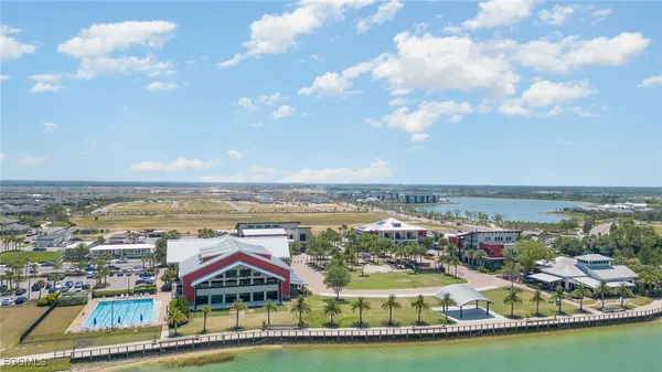 a view of a city with lots of residential buildings ocean and mountain view in back