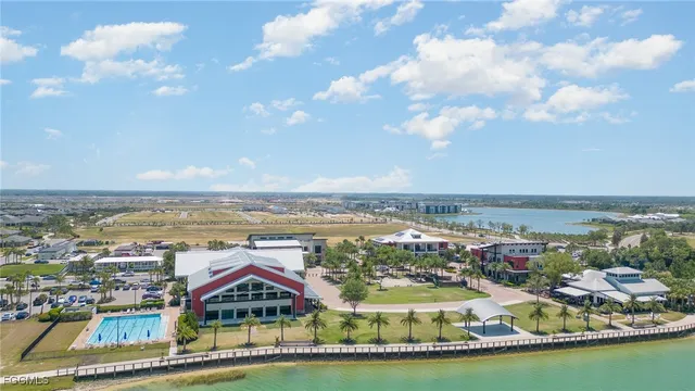 a view of a city with lots of residential buildings ocean and mountain view in back