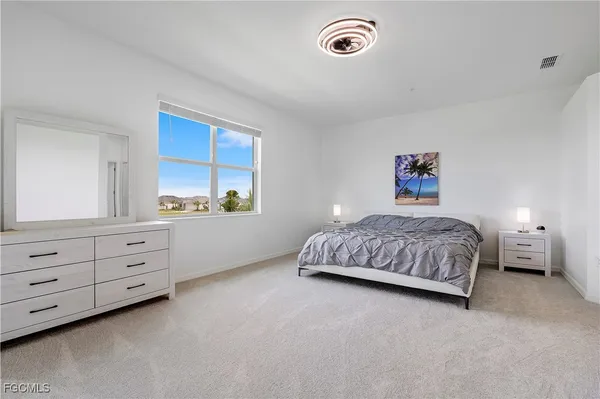 a bedroom with a bed and a dresser