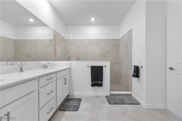 a spacious bathroom with a sink and mirror
