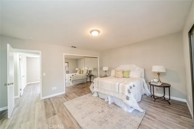 a bedroom with a bed and a large window