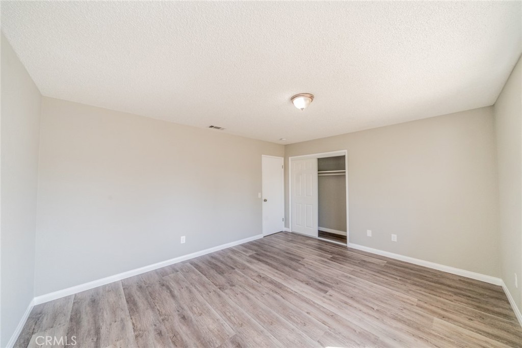 17470 Krameria Avenue Riverside, CA 92504 - Photo 23 of 53 a view of an empty room with wooden floor