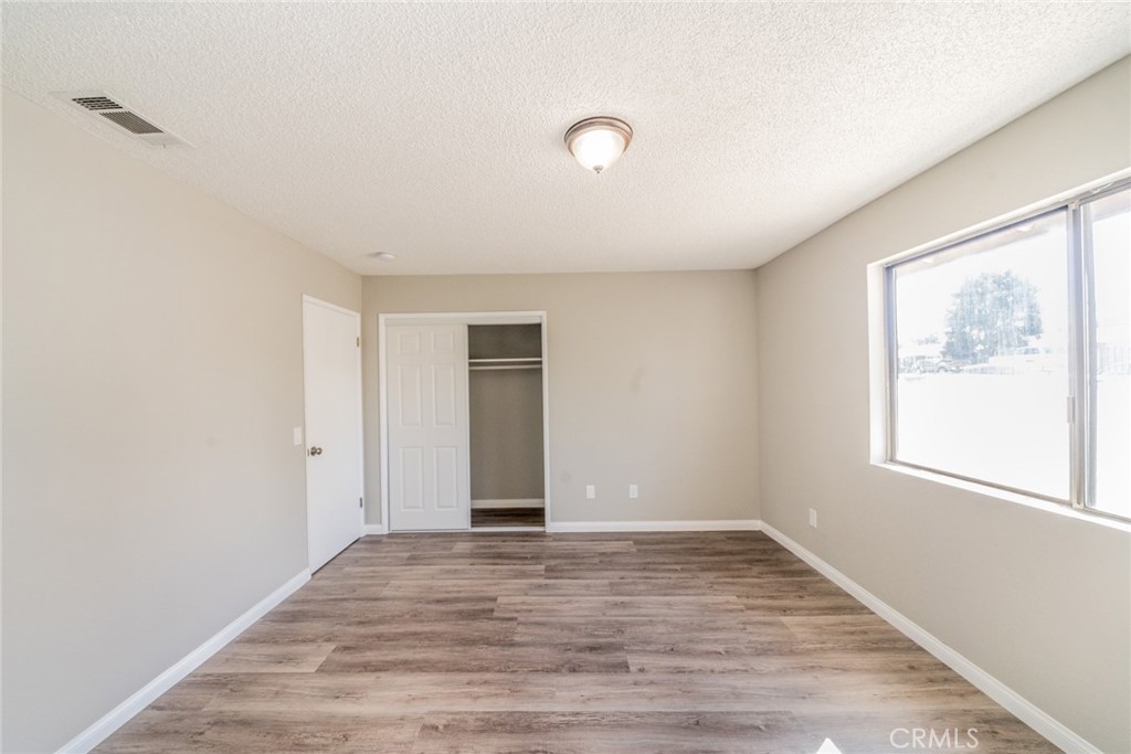 17470 Krameria Avenue Riverside, CA 92504 - Photo 24 of 53 an empty room with wooden floor and windows
