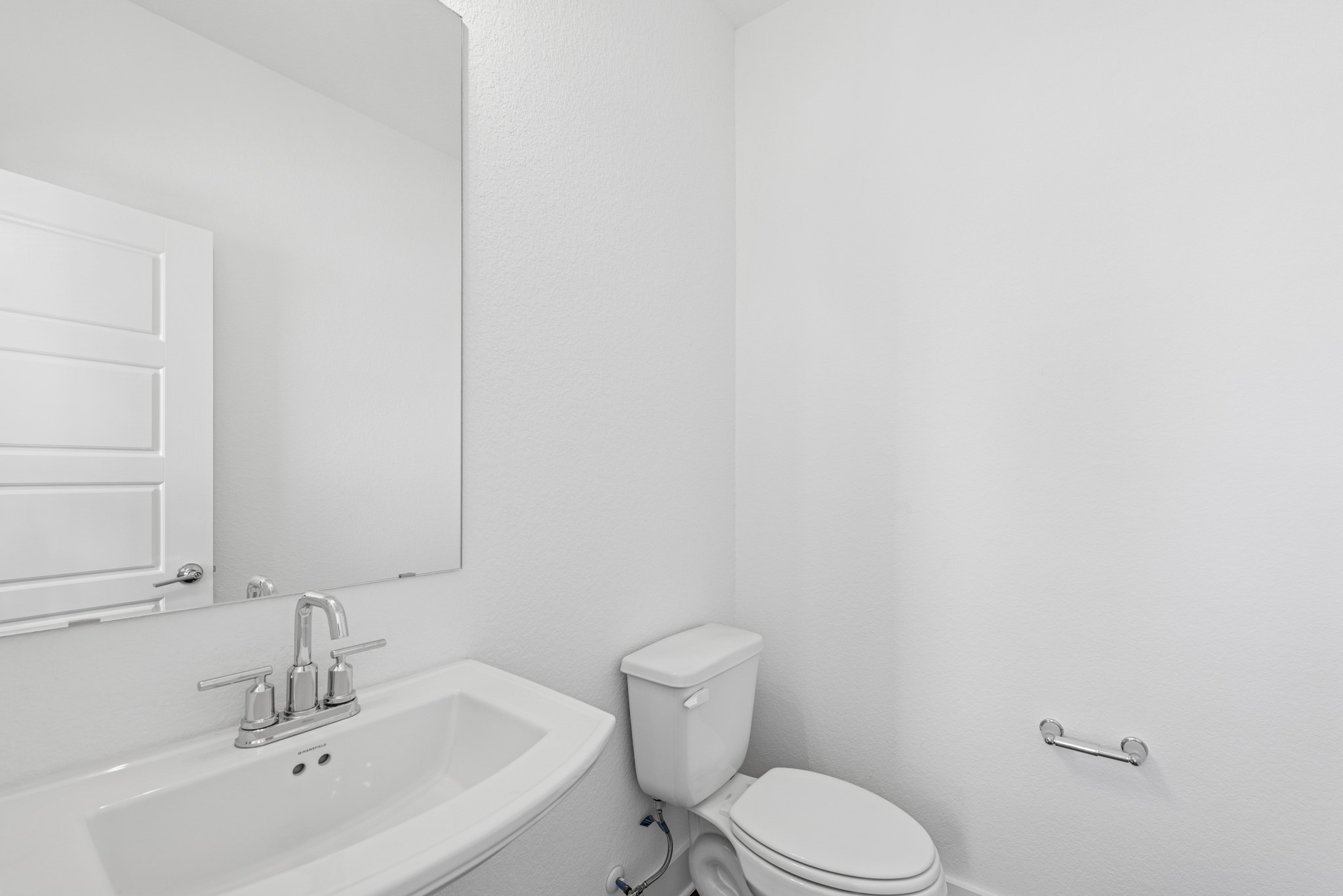 20518 Draper Road Tomball, TX 77377 - Photo 17 of 46 a bathroom with a toilet sink and mirror