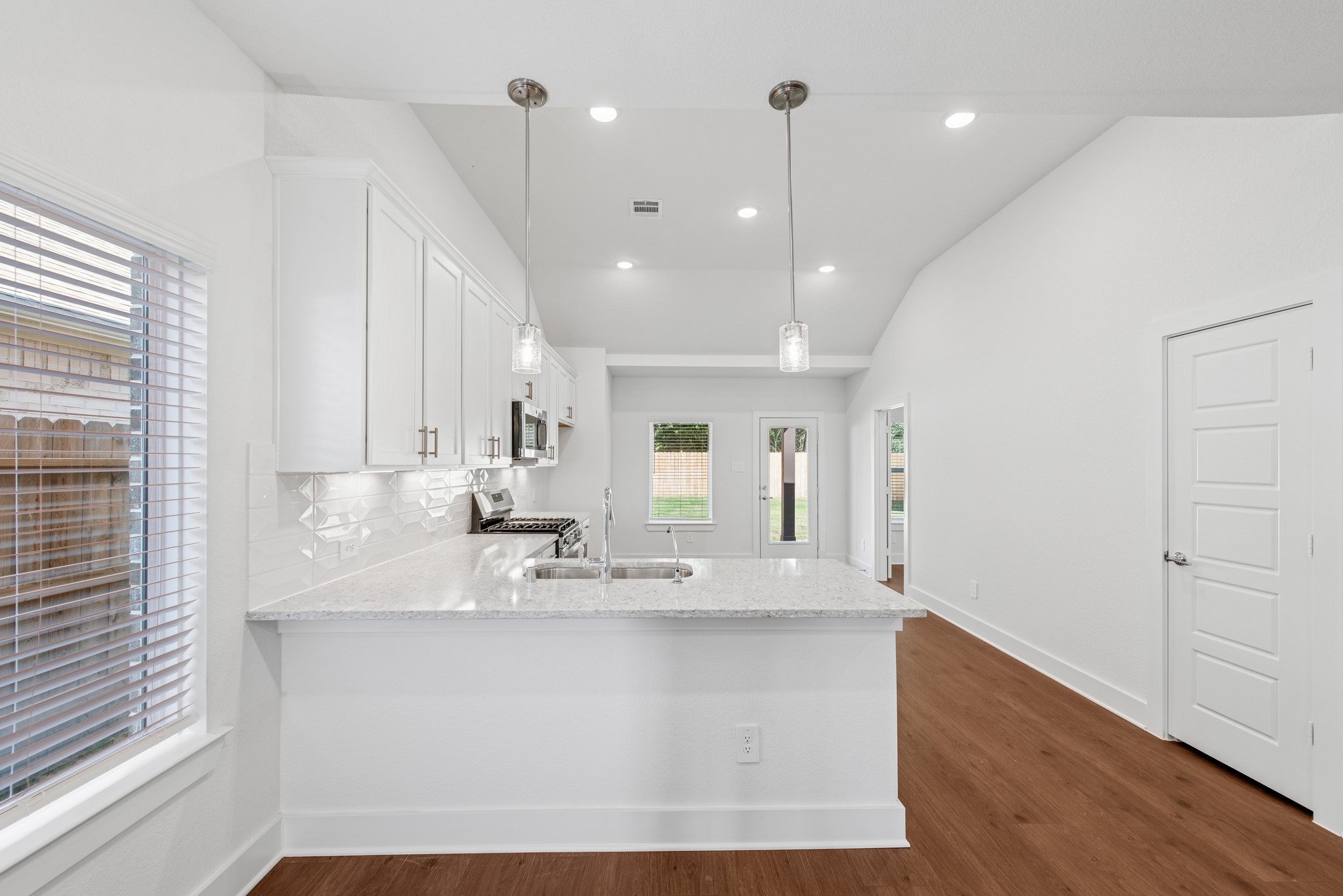 20518 Draper Road Tomball, TX 77377 - Photo 21 of 46 a large kitchen with kitchen island a sink stainless steel appliances and cabinets