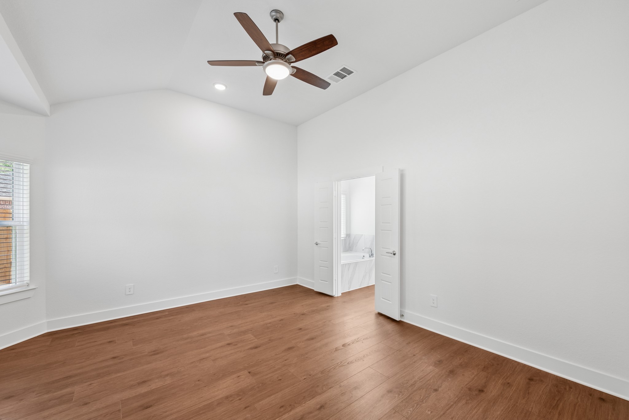 20518 Draper Road Tomball, TX 77377 - Photo 26 of 46 an empty room with wooden floor and windows