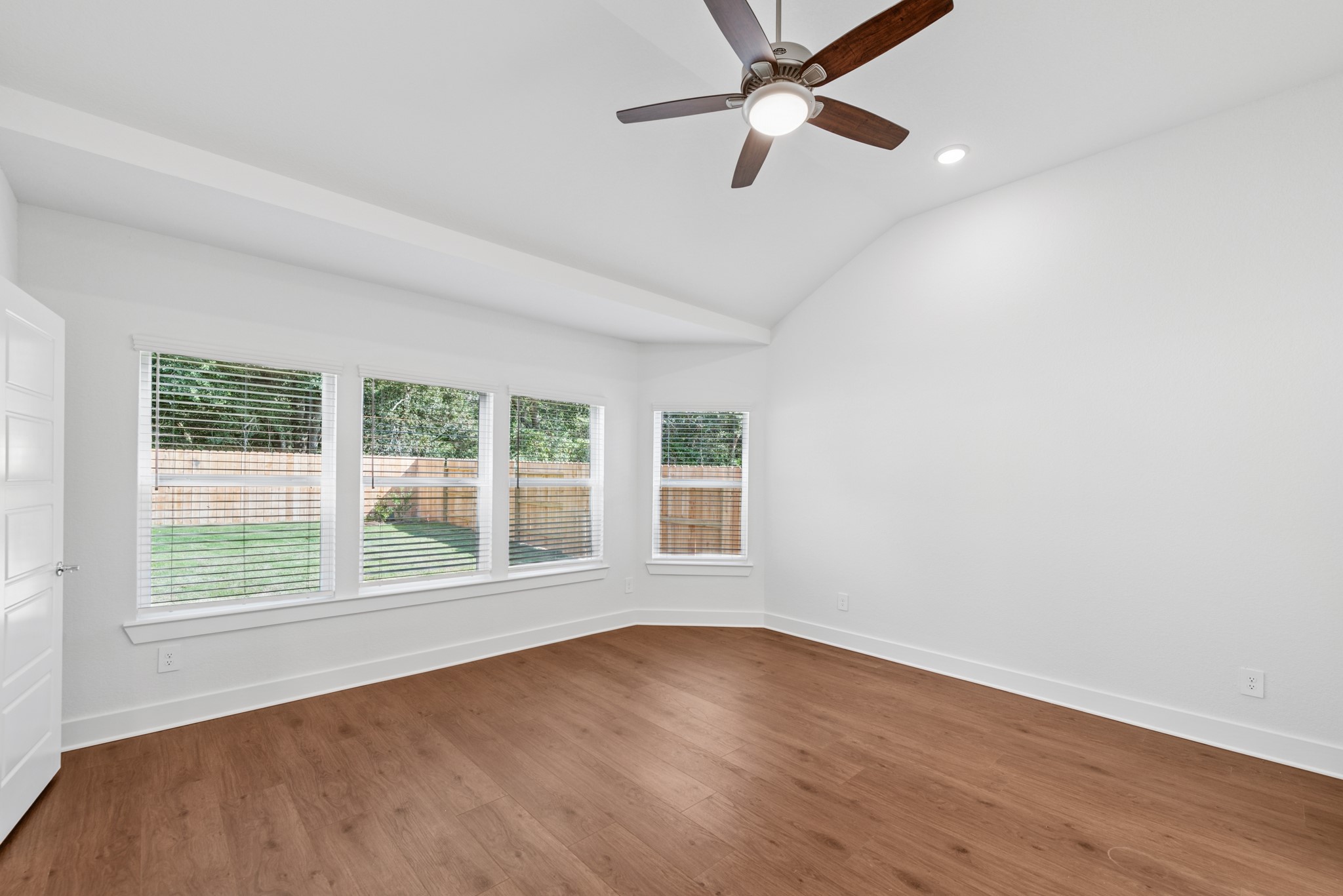 20518 Draper Road Tomball, TX 77377 - Photo 27 of 46 an empty room with wooden floor fan and windows