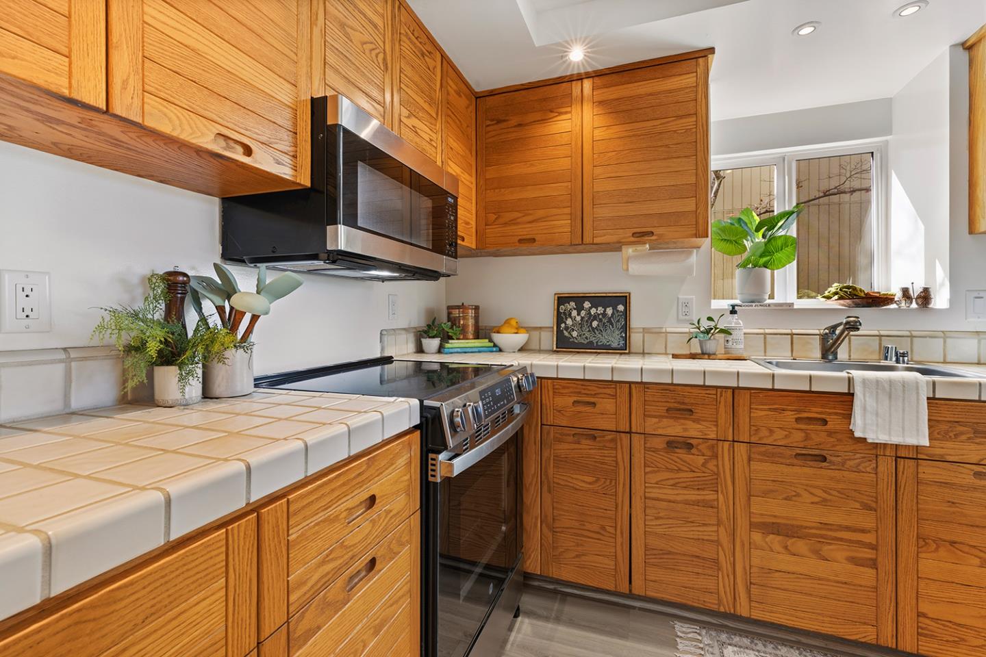 11 Berkeley Court Santa Cruz, CA 95062 - Photo 21 of 50 a kitchen with stainless steel appliances kitchen island granite countertop a sink a stove a oven a dining table and chairs