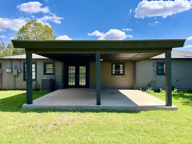 a view of a patio with a table and chairs