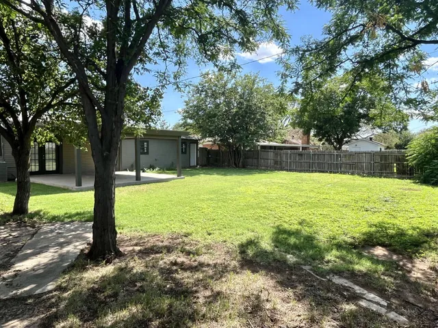 a swimming pool with outdoor seating and yard