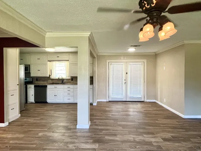 a view of a kitchen cabinets and a wooden floor