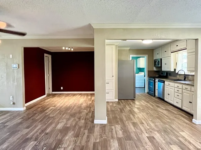 a view of a kitchen with stove and cabinets