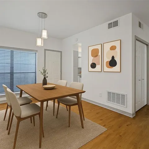 a view of a room that has a table and chairs