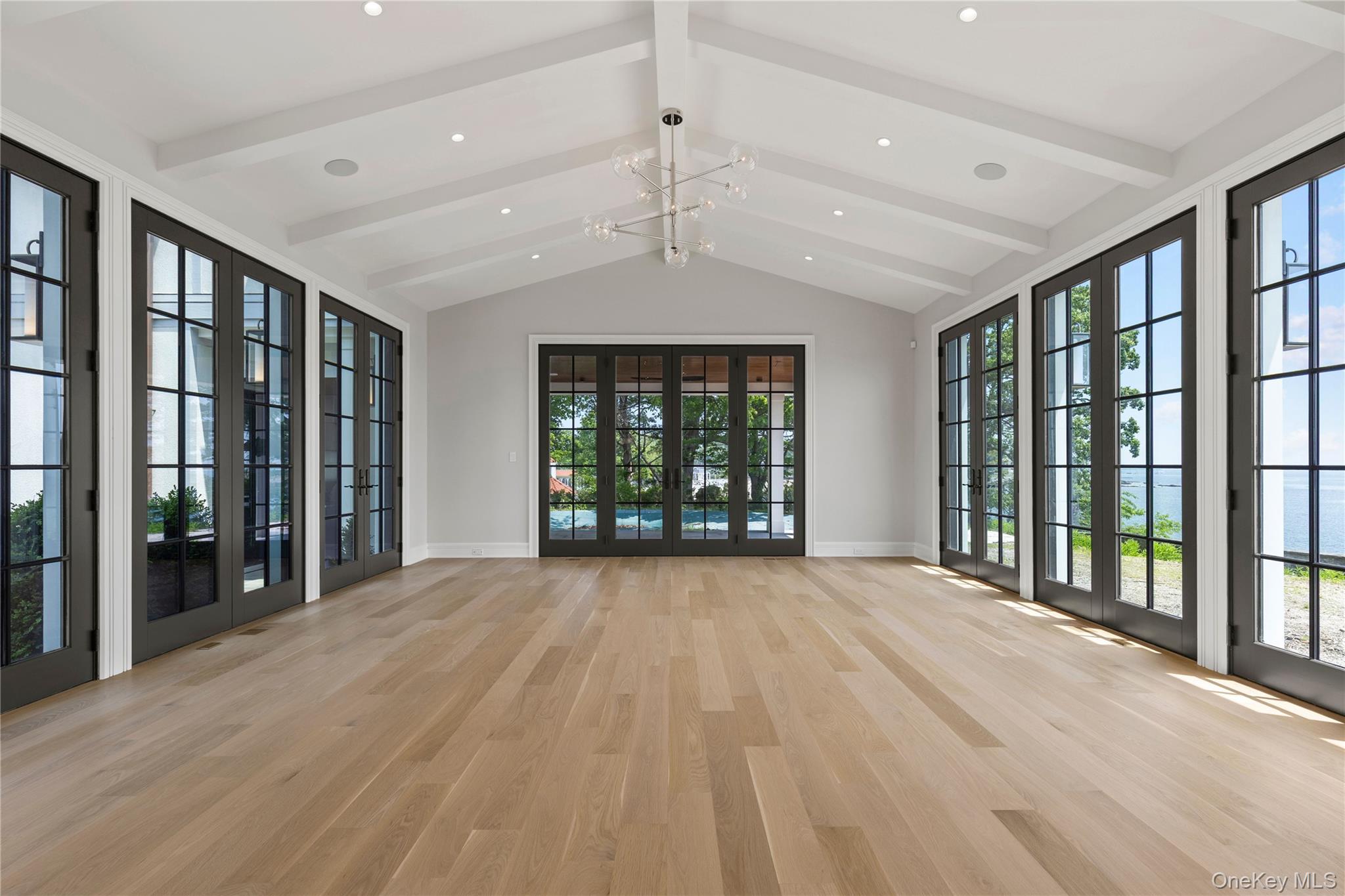 104 Premium Point Larchmont, NY 10538 - Photo 13 of 36 a view of an empty room with wooden floor and a window