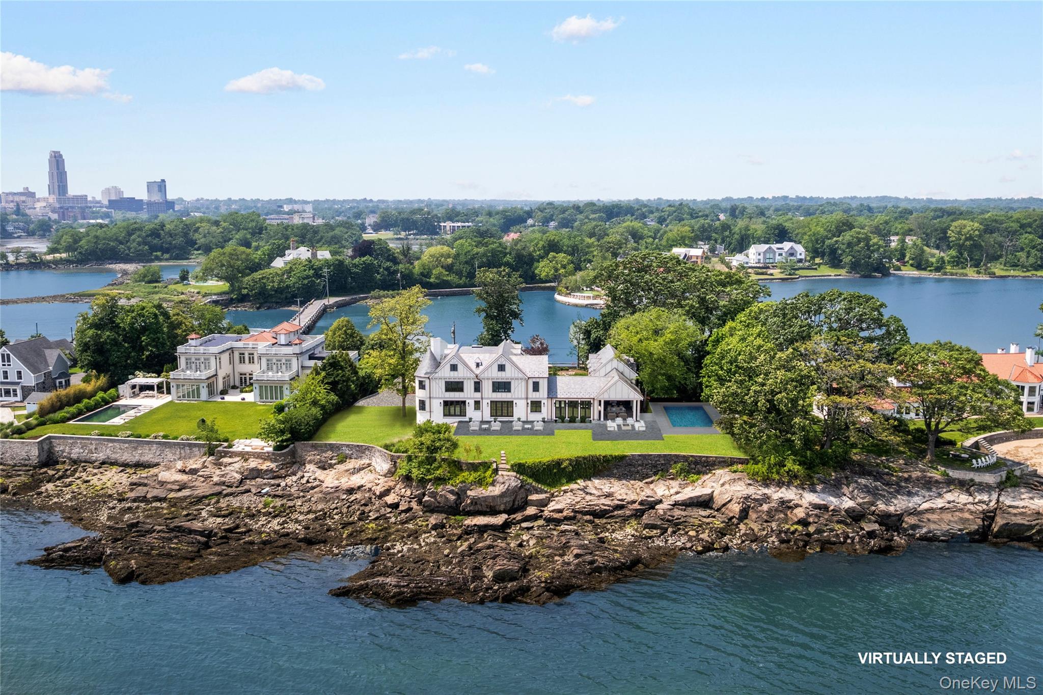 104 Premium Point Larchmont, NY 10538 - Photo 2 of 36 an aerial view of a house with a garden and lake view