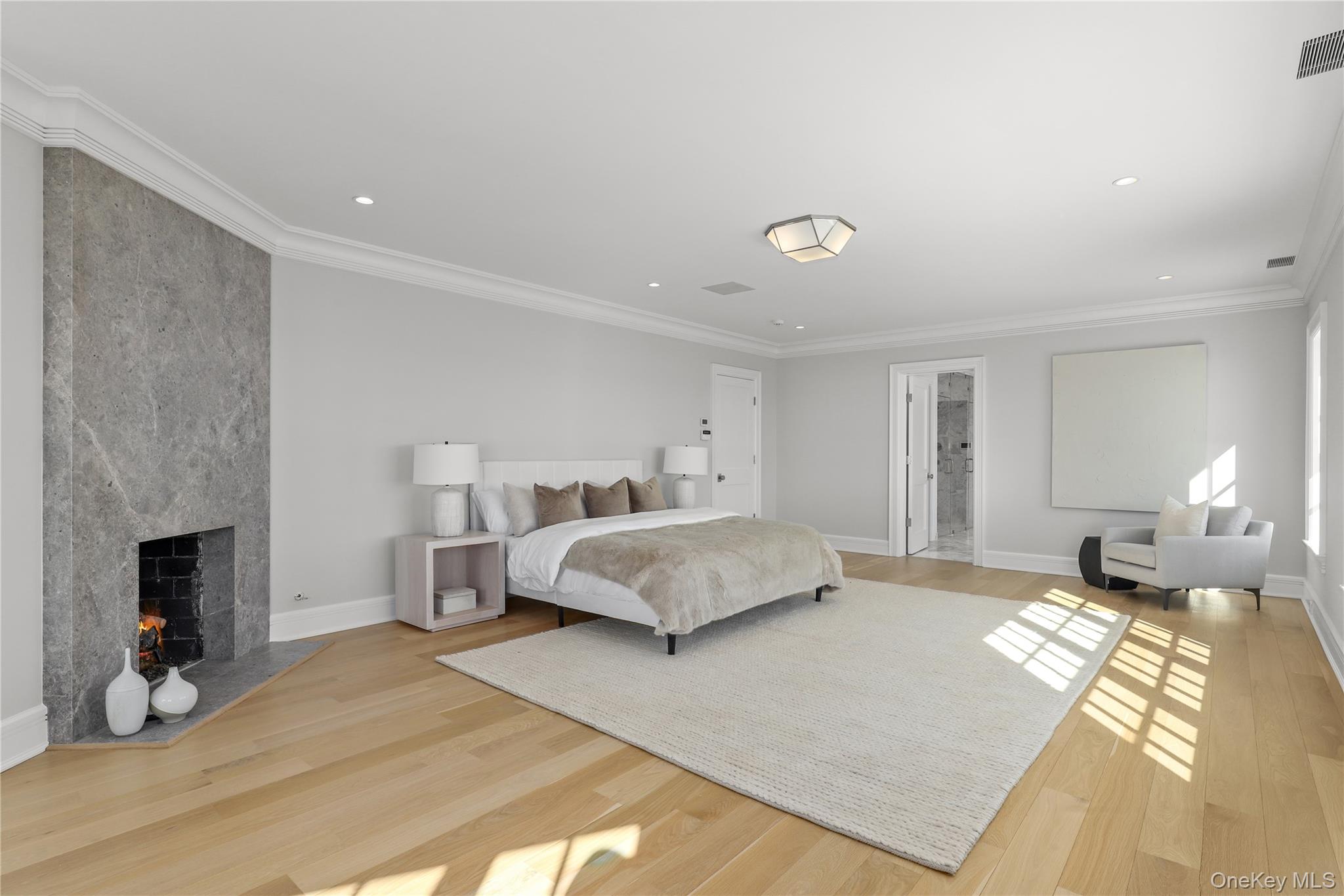 104 Premium Point Larchmont, NY 10538 - Photo 21 of 41 a spacious bedroom with a bed and a fireplace