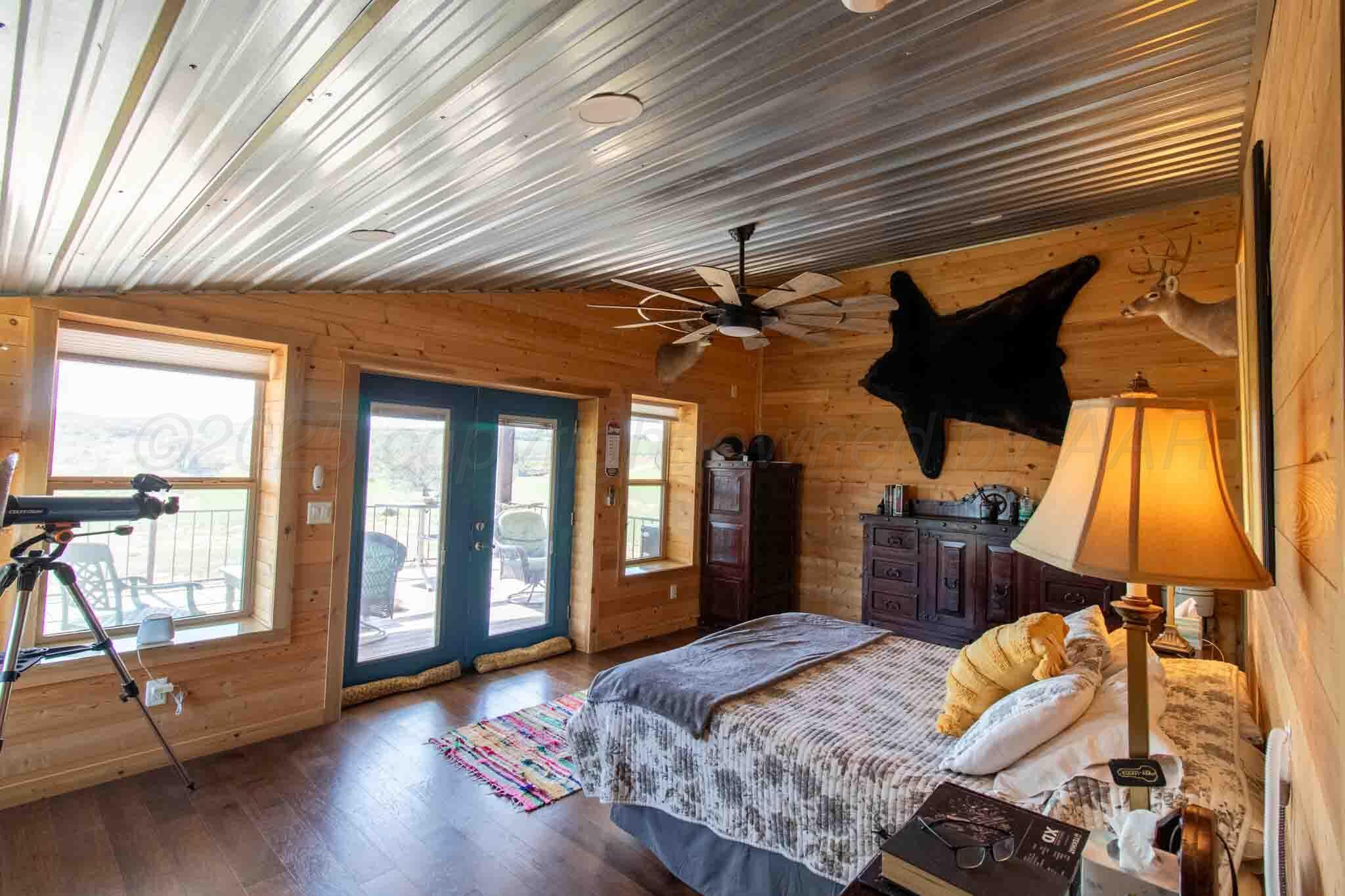 140 Mm Ranch Shamrock, TX 79079 - Photo 31 of 76 a bedroom with a bed and wooden floor