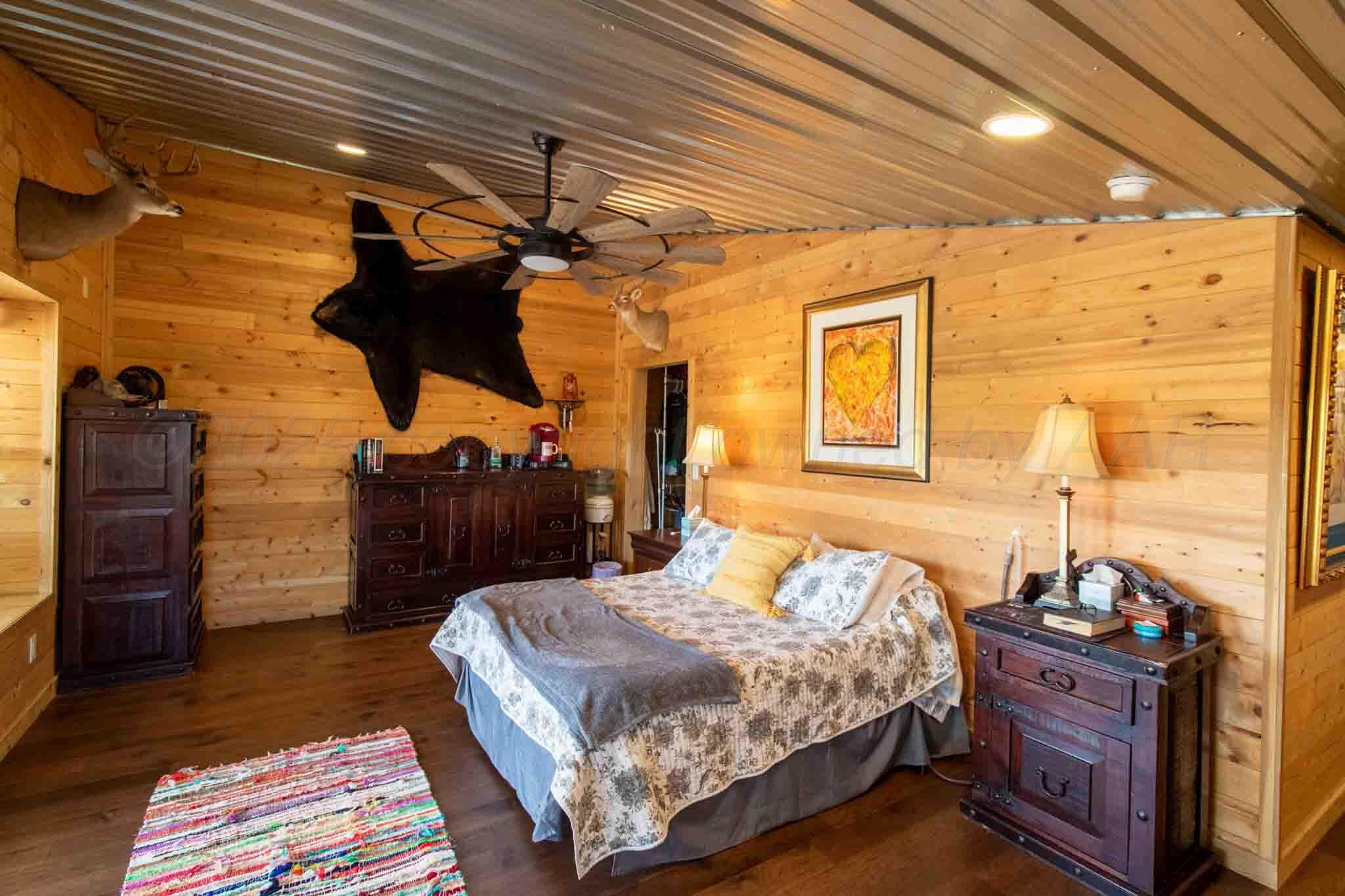 140 Mm Ranch Shamrock, TX 79079 - Photo 33 of 76 a bedroom with a bed and wooden floor