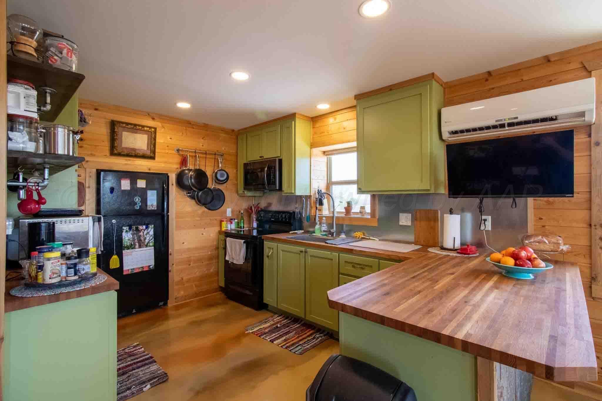 140 Mm Ranch Shamrock, TX 79079 - Photo 40 of 76 a kitchen with stainless steel appliances kitchen island granite countertop a sink and cabinets