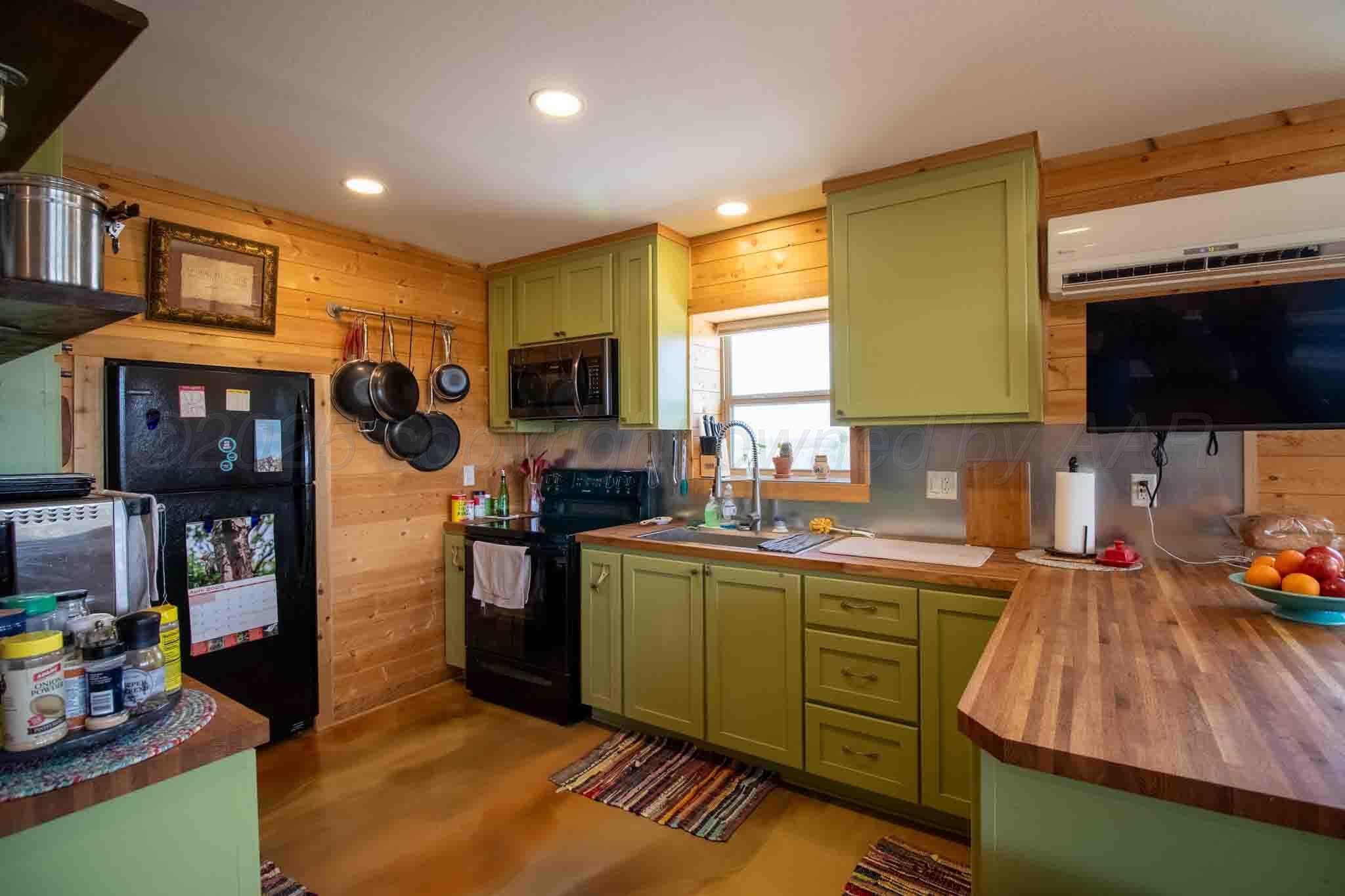 140 Mm Ranch Shamrock, TX 79079 - Photo 42 of 76 a kitchen with stainless steel appliances kitchen island granite countertop a sink and cabinets