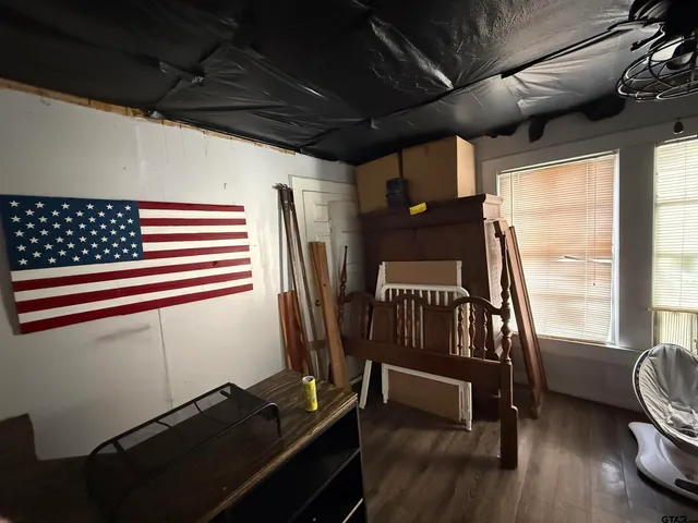 a view of a room with wooden floor and furniture