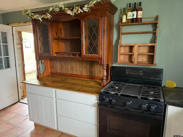 a kitchen with granite countertop a stove and a cabinet