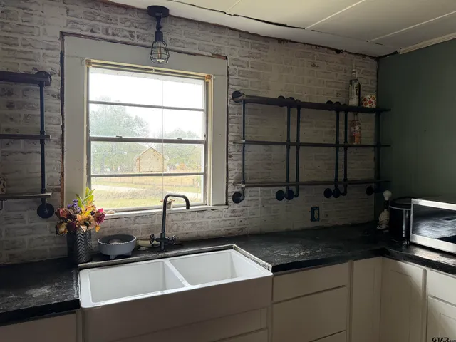 a kitchen with a sink and a window