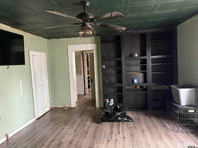 a view of a livingroom with furniture and an empty room