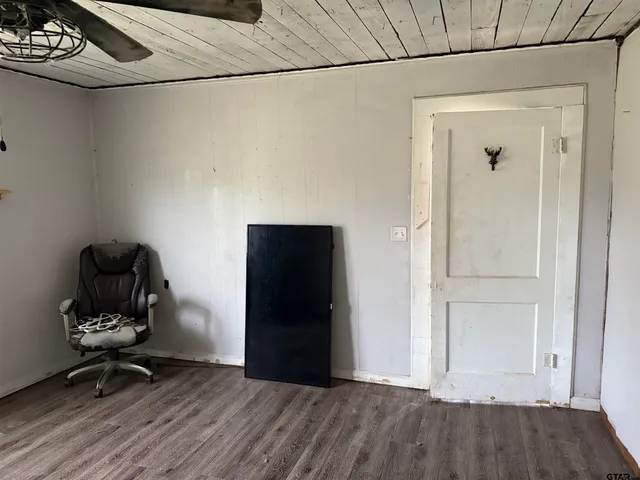 a view of a livingroom with wooden floor and a sink