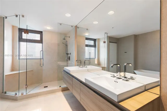a bathroom with a sink double vanity and shower