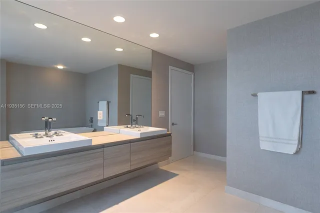 a bathroom with a double vanity sink and a mirror