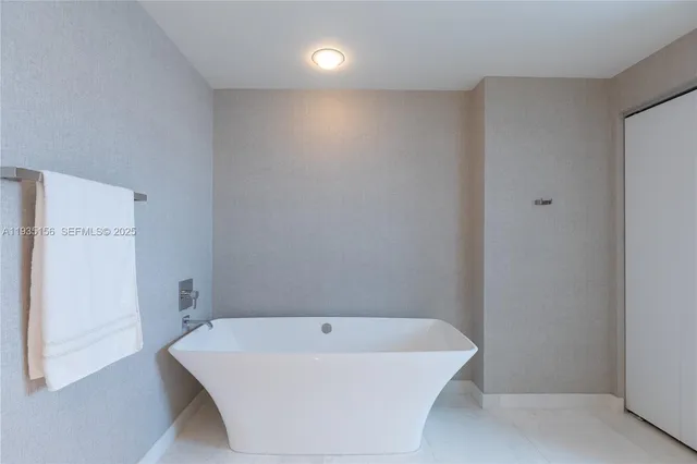 a white bath tub sitting in a bathroom