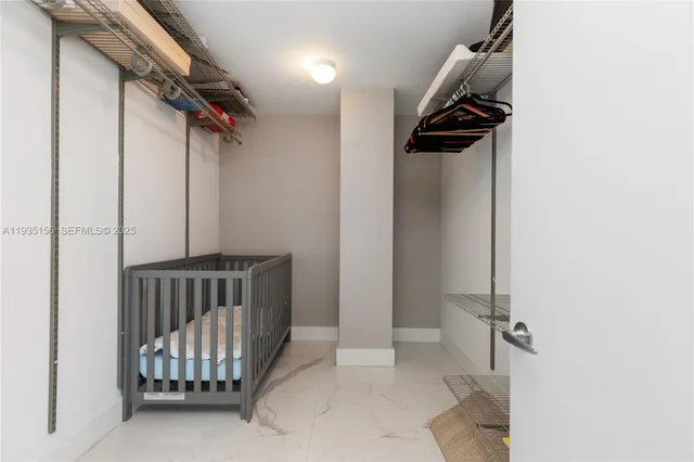 a bedroom with two large bed and a chandelier