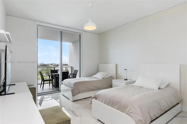 a bedroom with a large bed and a flat screen tv