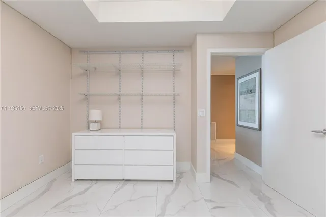 a view of a city from a balcony with seating space