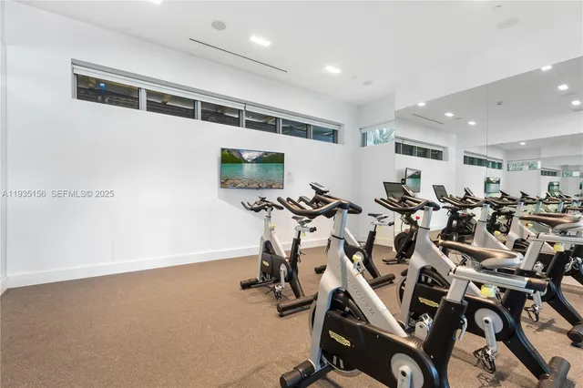 a view of a lake with boats and palm trees