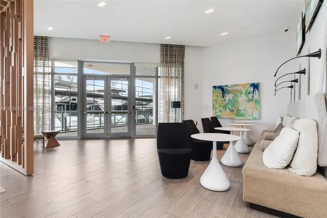 a front view of multi story residential apartment building with yard and entryway