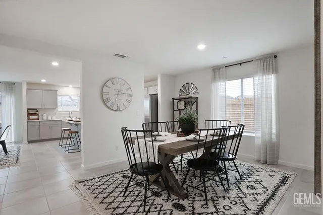 a view of a dining room with furniture and a large window