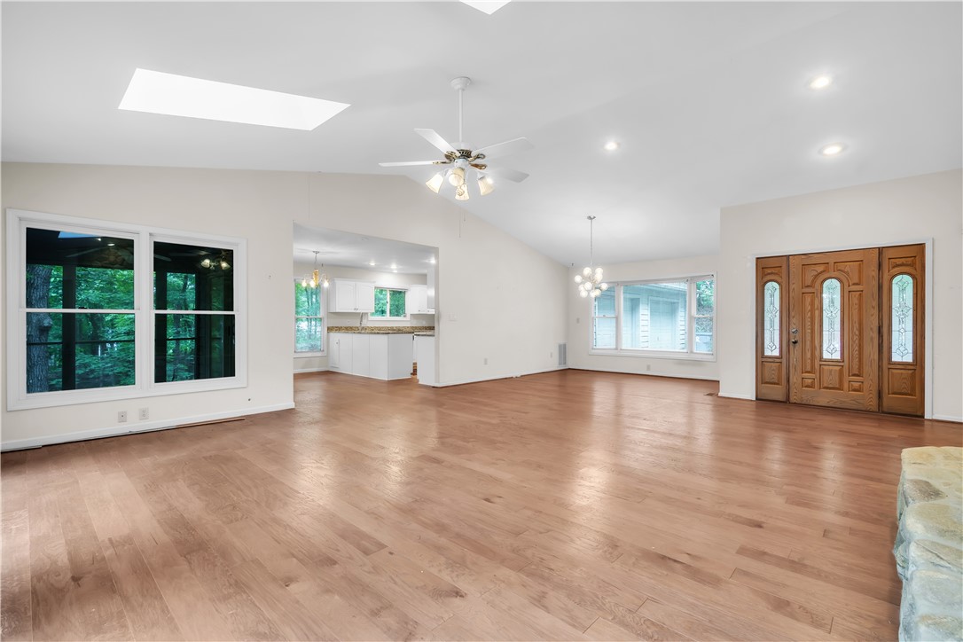 149 Inlet Pointe Drive Anderson, SC 29625 - Photo 2 of 43 Natural light and hardwood floors grace this spacious open-concept living area with soaring ceilings.