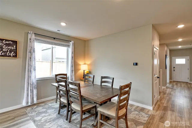a view of a dining room with furniture and wooden floor