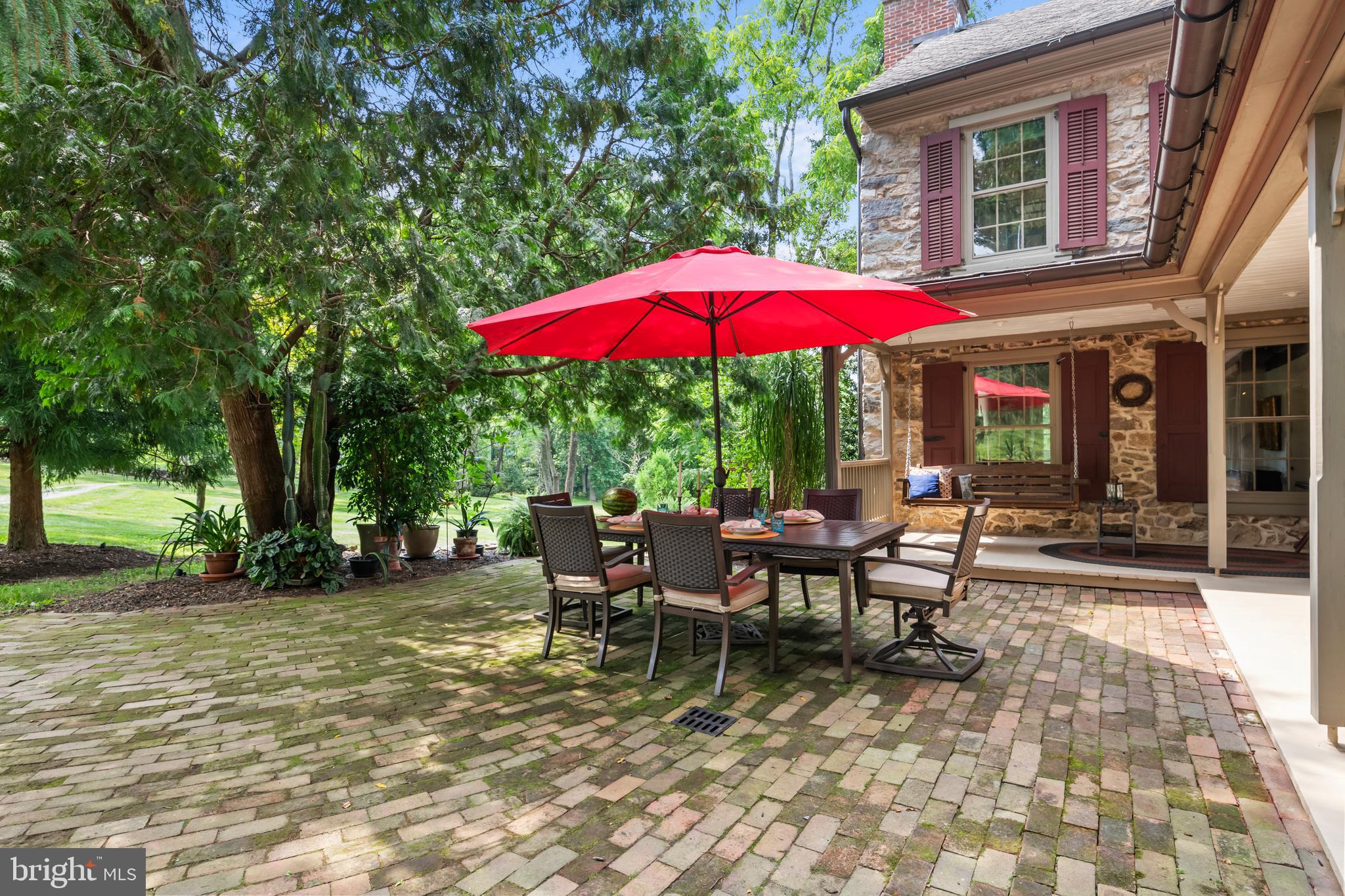 139 Mine Road Oley, PA 19547 - Photo 47 of 86 a view of a patio with a table and chairs under an umbrella