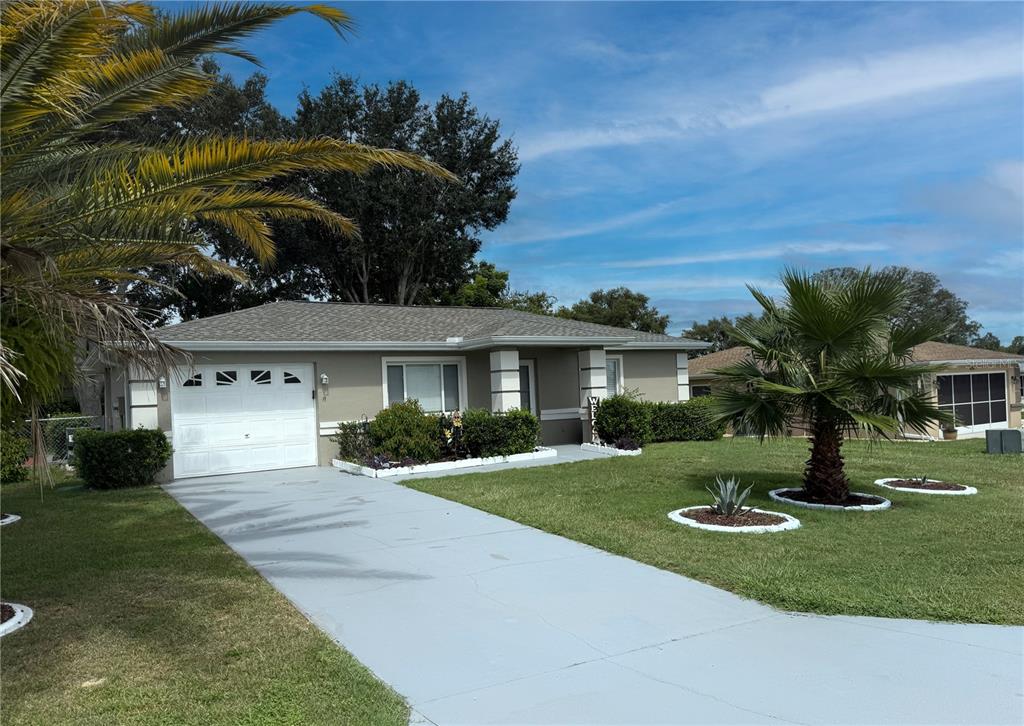 6102 Southwest 98th Loop Ocala, FL 34476 - Photo 1 of 1 a front view of a house with a garden