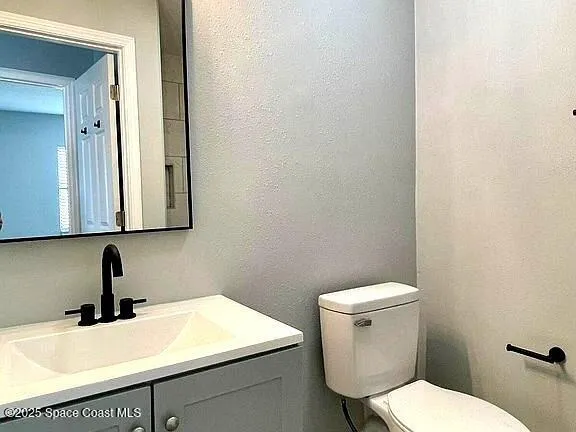 a bathroom with a sink a toilet and mirror