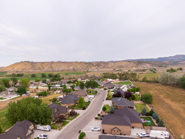 3565 West 1350th Street North Vernal, UT 84078 - Photo 54 of 54 Residential neighborhood with individual homes, paved streets, established landscaping, and surrounding natural terrain