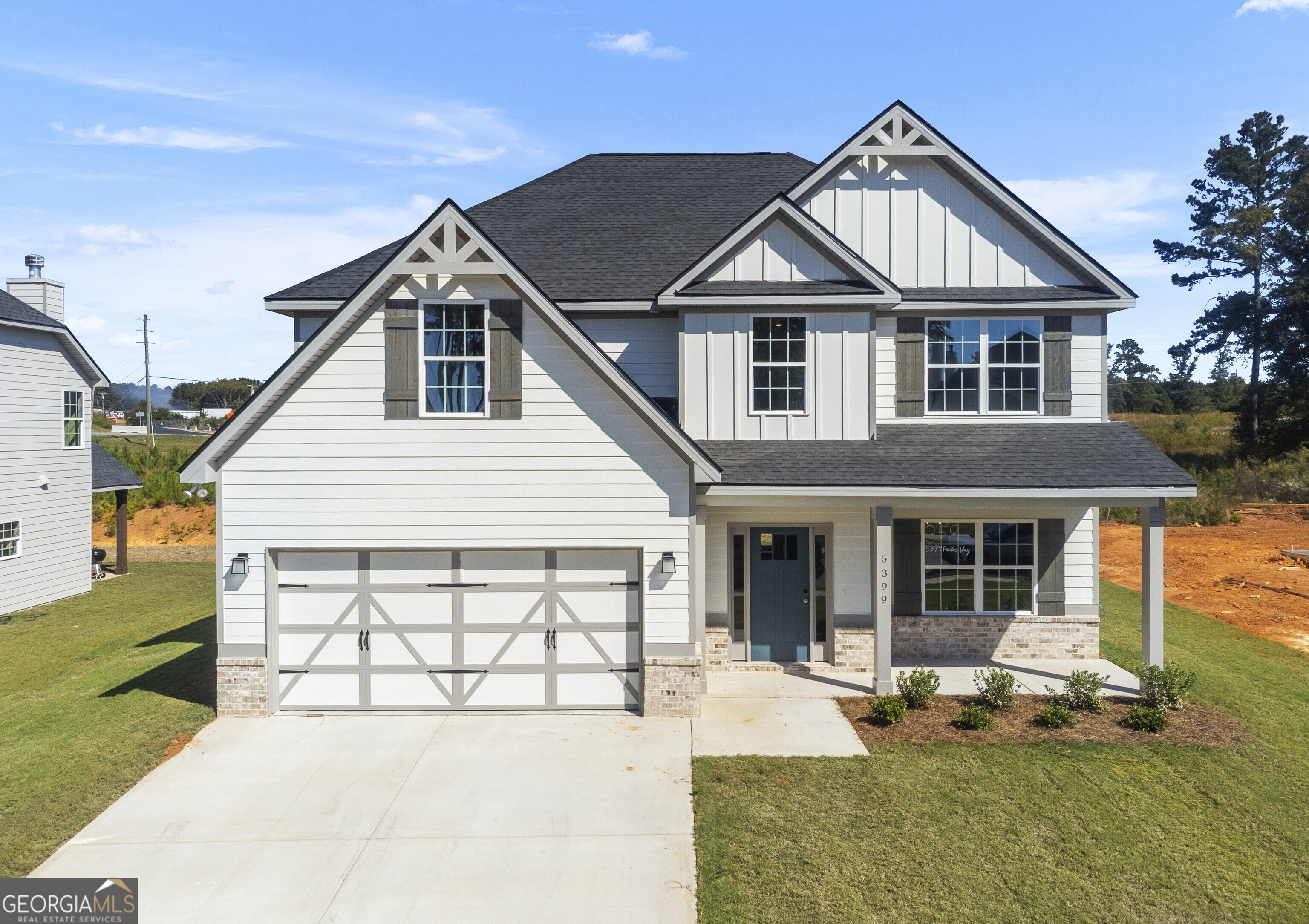 a front view of a house with a yard outdoor seating and barbeque oven