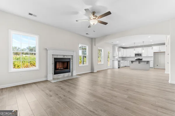 a kitchen with granite countertop white cabinets and a sink