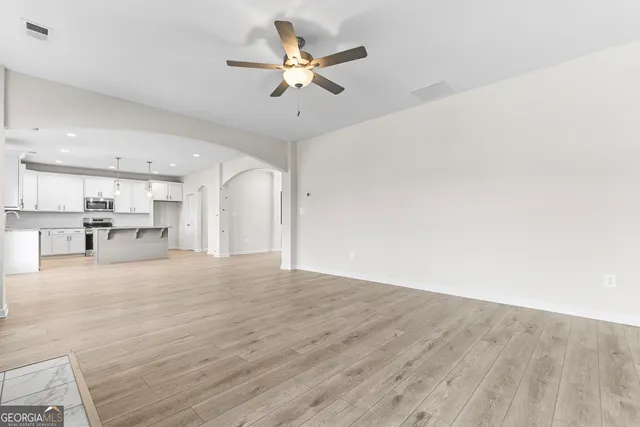 a kitchen with a center island and stainless steel appliances